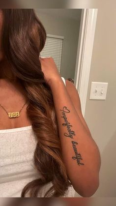 a woman wearing a white tank top with a gold necklace on her neck and the word faith written in cursive font