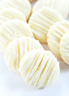 some white cookies are sitting on a plate