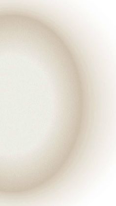 an empty white plate on a white background with some light coming from the top right corner