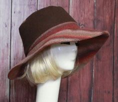 Wide Brim Sun Hat -Brown Wool with burgundy contrast print Inside black cotton band, the hat has a 2 section crown 3 1/2 " in length and a one piece 4" brim, and is lined in a cotton blend print. This hat is one size fits all and will fit 21" - 23" head size. Brown Hat Bands For Winter, One Size Fits Most, Brown Wide Brim Fitted Hat, Brown Sun Hat With Short Brim, One Size, Fitted Hat With Short Brim And Lining, Brown Brimmed Fedora One Size, Adjustable Brown Hat With Curved Brim, Brown Brimmed Cloche Hat, One Size Fits Most, Brown Brimmed Cloche Hat One Size, Brown Brimmed Cloche Hat