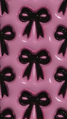 a pink background with black bows on it