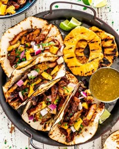 an overhead shot of tacos with pineapple salsa and grilled chicken on the side