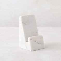 a white chair sitting on top of a white table