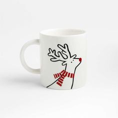 a white coffee mug with a red and black reindeer on it's side, in front of a white background