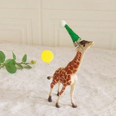 a toy giraffe with a party hat on its head