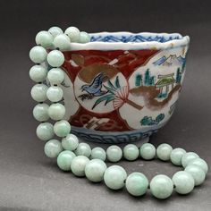 Style: Estate Burmese jade round bead necklace, natural color fei cui, with a matching silver clasp. 65 beads Material: Natural Jadeite, jadeite, vintage, Burmese jade, green, silver clasp Method: fine polished Type: Necklace, bead necklace Size: bead size gradual from 6.5 to 10mm, length 23.5" no.15 Traditional Jade Beaded Necklaces, Jade Beaded Necklace With Gemstone Beads, Beaded Jade Necklaces With Gemstone Beads, Jade Beaded Necklaces With Gemstone Beads, Elegant Round Jade Beaded Necklaces, Classic Jade Necklaces With Round Beads, Classic Jade Necklace With Round Beads, Jade Beaded Necklace With Polished Beads, Vintage Jade Jewelry Hand-strung