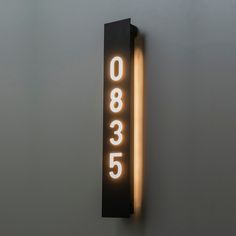 an illuminated sign on the wall that reads 008 535 in white letters and is lit up