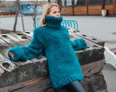 "MATERIAL : 8 strands mix of Suri Alpaca and wool COLOUR : Greenish blue ( There may be a slight difference because of the different monitors' representation) ♥ In the picture the model is wearing a garment with these measurements : A: ( Body Length) : 29.5 \" / 75 cm B: (Chest width) : 22 \" / 56 cm C : (Sleeve from armpit) : 21.7 \" / 55 cm D: (Neck unrolled) : 13.8 \" / 35 cm They are taken with the item laid flat and not streched. ♥ For choosing your size please look at size chart in our lis Winter Alpaca Knitting Pattern, Blue Knitting Pattern For Winter, Hand Knitted Blue Acrylic Sweater, Fall Blue Alpaca Sweater, Blue Hand Knitted Acrylic Sweater, Blue Hand-knitted Acrylic Sweater, Suri Alpaca, Pullover Sweater Men, Fluffy Sweater