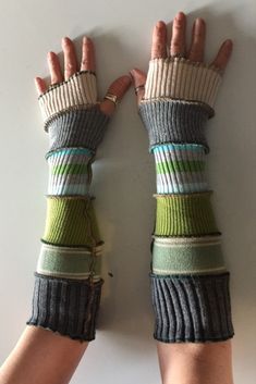 two hands wearing gloves made from fingerless gloves