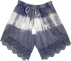 A stonewashed steel blue rayon shorts with white tie-dye in the mid - these cross shorts feature a beautiful crochet lace on the edges to enhance the bohemian look and cute drawstring tassels in white.  These pair of shorts have a streaky sophistication about them with the texture and fall. #tlb #Stonewash #Yoga #vacationclothing #beachwrap #TieDye #bohemianfashion #BohemianShorts #TieDyeShorts #BeachShorts Bohemian Style Shorts With Crochet Trim For Summer, Bohemian Shorts With Crochet Trim For Vacation, Blue Bohemian Shorts For The Beach, Blue Bohemian Shorts For Beach, Bohemian Blue Shorts For The Beach, Bohemian Blue Shorts For Beach, Summer Festival Bottoms With Crochet Trim, Bohemian Bottoms With Crochet Trim For Summer, Bohemian Summer Bottoms With Crochet Trim