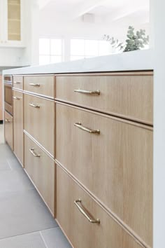 a kitchen with wooden cabinets and white counter tops