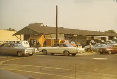 old cars are parked in a parking lot