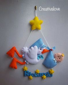 a baby's name hanging on the wall with a stork and stars