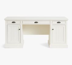 a white desk with two doors and drawers