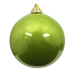 a green ornament hanging from a gold colored metal hook on a white background