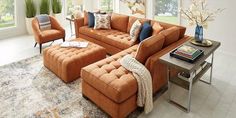 a living room with orange couches and chairs