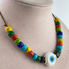 Evil Eye Colorful Necklace, Beaded Necklace, Glass Jewelry Women, Handmade Jewelry, Summer Gifts, Leather Cord, Turkish Evil Eye Necklace Handmade evil eye necklace with leather cord includes colorful glass beads for women. Great for the eye lover of minimalist jewelry.  Extender Chain available. The use of leather in brown tones, white, red, and green handmade oval glass beads, gold materials, gold closure, and gold chain extension. Length of necklace (end to end on a flat surface): 17'' (45 cm) Size of inline beads part: 3'' The necklace is produced individually and is a unique product for you. It is made of the highest quality materials; it does not tarnish in any way. Multicolor Evil Eye Beaded Necklaces With Round Beads, Green Evil Eye Round Beads Jewelry, Multicolor Evil Eye Necklace With Round Beads, Multicolor Evil Eye Necklace For Gift, Multicolor Evil Eye Beaded Necklaces, Bohemian Turquoise Evil Eye Necklace, Handmade Evil Eye, Crystal Bead Necklace, Summer Gifts