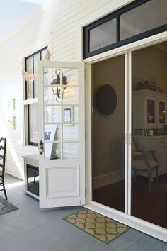 an open door leading to a room with a table and chairs on the outside patio