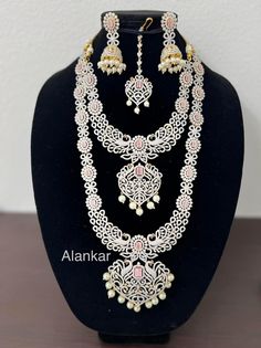 Indian imitation jewelry - this beautiful set is in 1 gram gold plated with all AD stones and pink CZ stones and with pearl drops. Dazzling Hand-set Kundan Necklace For Reception, Pink Hand Set Bridal Sets For Reception, Pink Diamond Bridal Earrings For Wedding, Elegant Pink Bridal Set With Stone Work, Festive Hand-set Kundan Necklace With American Diamonds, Elegant Heavy Pink Tikka, Hand-set Crystal Kundan Necklace For Wedding, Gold Multi-stone Kundan Temple Necklace, Gold Kundan Multi-stone Temple Necklace