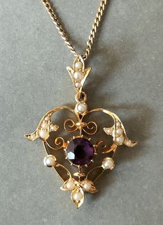 Beautiful Victorian 15ct Gold Amethyst Heart Pendant. This superb quality Pendant has a beautiful coloured amethyst measuring 6mm x 6mm. It is a really pretty design set with natural seed pearls as was typical of the Victorian era. This is very wearable piece of Antique Jewellery in excellent condition. The hallmark is rubbed down but 15ct can be seen. Pendant is on a lovely fully hallmarked 9ct gold chain measuring 46cm. The pendant measures 3.3cm x 2.5cm including the bale. Total Weight 5.1g P Vintage Amethyst Jewelry, Antique Victorian Jewelry, Formal Heart Cut Amethyst Jewelry, Yellow Gold Amethyst Heart Cut Jewelry, Formal Amethyst Jewelry For Valentine's Day, Purple Heart Cut Jewelry For Formal Events, Purple Heart Cut Jewelry For Formal Occasions, Formal Purple Heart-shaped Jewelry, Purple Heart Jewelry For Formal Occasions