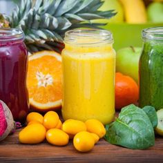 several jars filled with different types of fruit and veggies next to each other