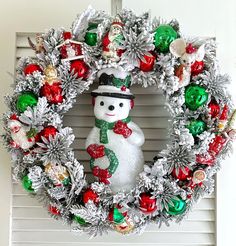 a christmas wreath with a snowman on it