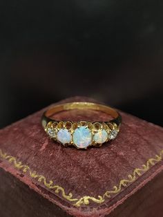 This stunning antique ring dates from the late Victorian era featuring Chester Hallmarks for either 1887 or 1897 for 18ct yellow gold. The ring is set with three amazing colourful natural opal gemstones with diamond assets totaling approx 0.15 carat.  UK size - K US size - 5.25  Message me any questions Vintage Hallmarked Opal Ring For Anniversary, Victorian Gold Opal Ring Gift, Vintage Yellow Gold Opal Ring, Antique Gold Cluster Ring, Victorian Round Opal Ring Hallmarked, Victorian Style Gold Oval Cluster Ring, Victorian Hallmarked Opal Ring, Victorian Style Oval Gold Cluster Ring, Victorian Oval Gold Cluster Ring