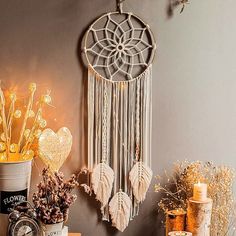 a table topped with vases filled with flowers next to a clock and other items