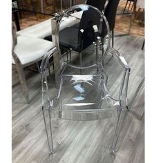 a clear chair sitting on top of a wooden floor