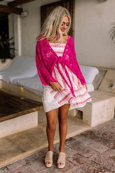 - Set sail in this beautiful crochet tie top! - Hot pink colored crochet material - Loose, three-quarter length sleeves - Open draped silhouette that ends in an uneven hemline perfect for front tie closure Pink Lace Crochet Top For Beach, Pink Lace Crochet Top For The Beach, Pink Crochet Top For Spring Vacation, Spring Vacation Pink Crochet Top, Pink Open Knit Crochet Top For Beach, Pink Open Knit Crochet Top For The Beach, Pink Long Sleeve Crochet Top For Summer, Pink Crochet Top For Vacation, Pink Crochet Top With Crochet Trim For Vacation