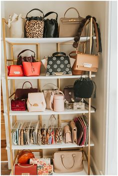 a closet filled with lots of purses and handbags next to a wall mounted shelf