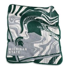 the michigan state university blanket is shown in green and white with an image of a woman's head on it