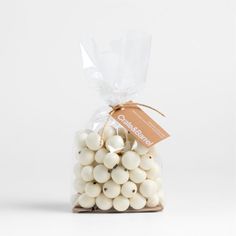 a bag filled with white chocolate balls on top of a table