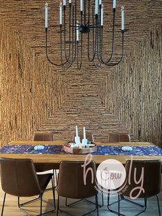 a dining room table with chairs and a chandelier hanging from the ceiling above it