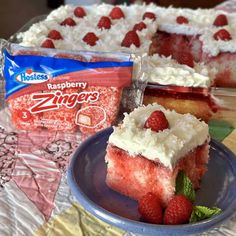 a piece of cake on a plate with raspberries