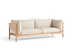 a white couch sitting on top of a wooden frame