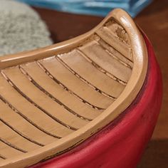 a wooden boat sitting on top of a table