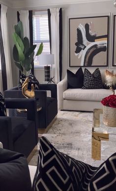 a living room filled with black and white furniture