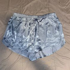 Satin Shorts Size Medium Never Worn Silver Stretch Bottoms Short Length, Silver Stretch Bottoms For Summer, Summer Pajama Shorts For Night Out, Silver Short Bottoms For Night Out, Silver Bottoms For Night Out, Short Length, Casual Metallic Shorts, Silver Short Length Bottoms For Night Out, Metallic Short Bottoms For Summer, Silver Bottoms With Built-in Shorts