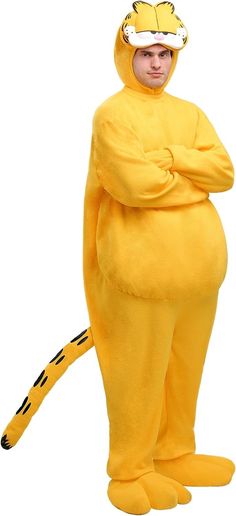 a man in a yellow costume standing with his arms crossed