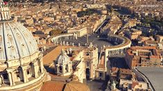 an aerial view of a city with many buildings and large dome structures in the center