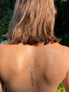 a woman with a tattoo on her back