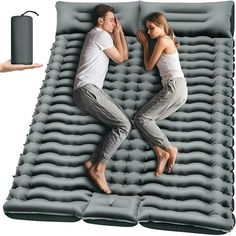 two people are laying on an inflatable mattress with a phone attached to it