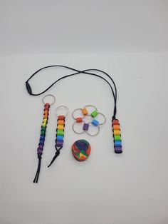 a group of items that include bracelets, beads, and rings on a white surface