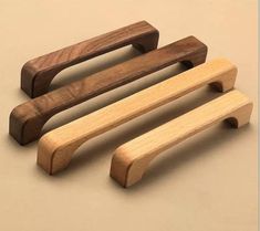 three wooden door handles on a beige background