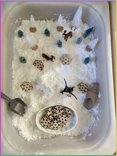 a bath tub filled with white foam and toys