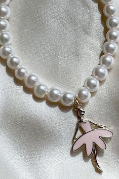 The most precious summer accessory ~ cute as can be and the perfect pop of pearl! Name a better accessory to your LoveShackFancy pieces. Handmade One size fits most ~ elastic band Pearl bracelet with charm detail White Pearl Stretch Bracelet With Pearl Charm, Cute Pearl Charm Jewelry, Cute Pearl Jewelry With Pearl Charm, Summer White Pearl Bracelet, Trendy Adjustable Bracelet With Pearl Charm, White Pearl Charm Bracelet, Trendy Summer Jewelry With Pearl Charm, Trendy Adjustable Pearl Bracelet For Party, Adjustable Trendy Pearl Bracelet For Party