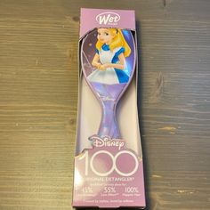 the disney princess toothbrush is in its box on top of a wooden table and it's packaging