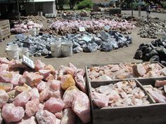 several boxes filled with pink rocks on the ground