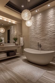 a bathroom with a large bathtub and two lights hanging from the ceiling above it